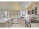 Well-lit kitchen with stainless appliances, lots of countertop space and views to the outside at 2806 E Pontiac Dr, Phoenix, AZ 85050