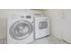Modern laundry room featuring side by side Samsung washer and LG dryer against neutral walls at 2806 E Pontiac Dr, Phoenix, AZ 85050