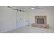 Living room featuring a brick fireplace, tile floors, and a white sliding barn door at 2806 E Pontiac Dr, Phoenix, AZ 85050