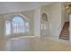 Bright living room featuring large windows, light wood floors, and staircase leading to the upper level at 2806 E Pontiac Dr, Phoenix, AZ 85050