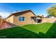This spacious backyard with block wall features lush grass and covered patio at 3017 W Matthew Dr, Phoenix, AZ 85027