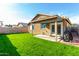 Enjoy the spacious backyard, featuring lush green grass, a covered patio, and a BBQ at 3017 W Matthew Dr, Phoenix, AZ 85027