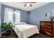 Bedroom with a light-filled window and wicker accents at 3017 W Matthew Dr, Phoenix, AZ 85027