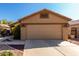 Traditional home with a brown garage door, desert landscaping, and an inviting driveway at 3017 W Matthew Dr, Phoenix, AZ 85027