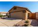 Side view of a home with a two car garage and desert landscaping at 3017 W Matthew Dr, Phoenix, AZ 85027