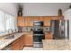 Kitchen with stainless steel appliances, granite countertops, tile backsplash and wood cabinets at 3017 W Matthew Dr, Phoenix, AZ 85027
