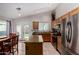 Bright kitchen featuring granite counters, stainless steel appliances, an island, and backyard access at 3017 W Matthew Dr, Phoenix, AZ 85027