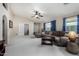 Open living room featuring neutral carpet, sectional seating and blue curtains at 3017 W Matthew Dr, Phoenix, AZ 85027