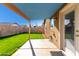 Enjoy outdoor living on this covered patio overlooking a lush green lawn and stucco block fence at 3017 W Matthew Dr, Phoenix, AZ 85027