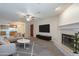 Bright living room featuring a fireplace, ceiling fan and access to the kitchen at 3031 N Civic Center Plz # 255, Scottsdale, AZ 85251