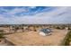 A birds eye view showcases a home in a desert neighborhood with spacious lots and detached garages at 30433 W Bellview St, Buckeye, AZ 85396