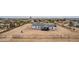 Aerial view of a single-story home with a spacious lot, fence, and detached garage buildings at 30433 W Bellview St, Buckeye, AZ 85396