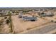 Wide aerial view of a property with detached garage, home, large yard, and fencing at 30433 W Bellview St, Buckeye, AZ 85396