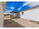 A covered back porch with gray painted floor provides outdoor living space with a view of the yard at 30433 W Bellview St, Buckeye, AZ 85396