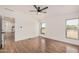 This bedroom has wood floors, white walls, and two windows offering views of the property at 30433 W Bellview St, Buckeye, AZ 85396