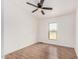 A bright bedroom with wood floors, a ceiling fan, and a window at 30433 W Bellview St, Buckeye, AZ 85396