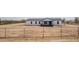 Charming single-story home with a front porch and simple landscaping behind a chain link fence at 30433 W Bellview St, Buckeye, AZ 85396