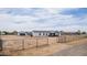 Wide view of a single-story home with a large lot, fenced yard, garage and inviting front porch at 30433 W Bellview St, Buckeye, AZ 85396