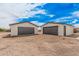 Two detached garages with gray doors provide ample parking and storage space on the property at 30433 W Bellview St, Buckeye, AZ 85396