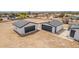 Two modern detached garages with sleek gray doors and white siding, on a large lot at 30433 W Bellview St, Buckeye, AZ 85396