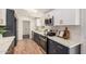 This modern kitchen features navy and white cabinets, stainless steel appliances, and a skylight at 30433 W Bellview St, Buckeye, AZ 85396