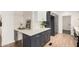 This kitchen features navy cabinets, white marble countertops and backsplash, and stainless steel appliances at 30433 W Bellview St, Buckeye, AZ 85396