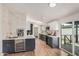 This kitchen features navy and white cabinets, wood floors, stainless steel appliances, and a wine fridge at 30433 W Bellview St, Buckeye, AZ 85396