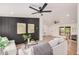 Modern living space featuring a stylish accent wall, comfortable seating, and an airy design at 30433 W Bellview St, Buckeye, AZ 85396