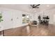 This bright living room features wood floors, white walls, and several windows to view the outdoors at 30433 W Bellview St, Buckeye, AZ 85396