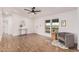 This open-concept living room features hardwood floors, white walls, and natural light at 30433 W Bellview St, Buckeye, AZ 85396