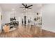 Open-concept living room with hardwood floors, stylish furnishings, and abundant natural light at 30433 W Bellview St, Buckeye, AZ 85396