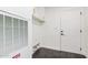 Mud room with black tile floors, white cabinets, and a back door at 30433 W Bellview St, Buckeye, AZ 85396