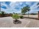 Paver patio in backyard with wrought iron fence and desert landscaping at 30458 N Sunray Dr, San Tan Valley, AZ 85143