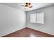Empty bedroom with a ceiling fan and window, with tile flooring at 30458 N Sunray Dr, San Tan Valley, AZ 85143