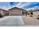 Charming single-story home with desert landscaping, a spacious driveway, and a two-car garage at 30458 N Sunray Dr, San Tan Valley, AZ 85143