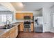 Well-lit kitchen features stainless steel appliances, wooden cabinets, and tile flooring at 30458 N Sunray Dr, San Tan Valley, AZ 85143