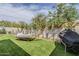 Secluded backyard with a relaxing hammock, artificial turf, and privacy fence for a tranquil outdoor experience at 3246 E Palm Ln, Phoenix, AZ 85008