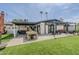 Lovely backyard with a covered patio, pergola, outdoor seating, and lush artificial turf, perfect for relaxing at 3246 E Palm Ln, Phoenix, AZ 85008