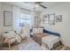 Cozy bedroom with hardwood floors, a daybed, a ceiling fan, and ample natural light at 3246 E Palm Ln, Phoenix, AZ 85008