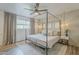 Bright bedroom with a four-poster bed, hardwood floors, a ceiling fan, and lots of natural light at 3246 E Palm Ln, Phoenix, AZ 85008