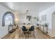 Bright dining room showcases a modern chandelier, arched window, and decorative wall art at 3246 E Palm Ln, Phoenix, AZ 85008
