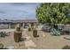 Charming home with desert landscaping, stone pathway, and mature trees at 3246 E Palm Ln, Phoenix, AZ 85008