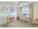Chic home office with a modern desk, a guitar, hardwood floors, a fan, and lots of natural light at 3246 E Palm Ln, Phoenix, AZ 85008
