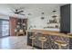 Stylish living room featuring a wet bar, a ceiling fan, hardwood floors, and a built-in bookshelf at 3246 E Palm Ln, Phoenix, AZ 85008
