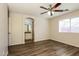 Bedroom with wood flooring, ceiling fan and doorway to an ensuite bathroom at 3323 W Fraktur Rd, Phoenix, AZ 85041