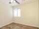 This bedroom is bright and airy with wood-look floors and a window with blinds for natural light at 3323 W Fraktur Rd, Phoenix, AZ 85041