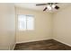 Bright bedroom with window and modern wood-look flooring at 3323 W Fraktur Rd, Phoenix, AZ 85041