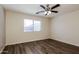Bright bedroom with hardwood flooring, fan, and window at 3323 W Fraktur Rd, Phoenix, AZ 85041
