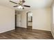Spacious bedroom with ceiling fan, wood floors, and ensuite bathroom entrance at 3323 W Fraktur Rd, Phoenix, AZ 85041