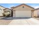 Beige one story home featuring a two car garage and low maintenance desert landscaping at 3323 W Fraktur Rd, Phoenix, AZ 85041